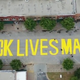 Illustration for article titled Tulsa Protesters Place Symbolic Tombstones With Names of Black Wall Street Victims on Black Lives Matter Mural in Last-Ditch Effort to Stop Its Removal